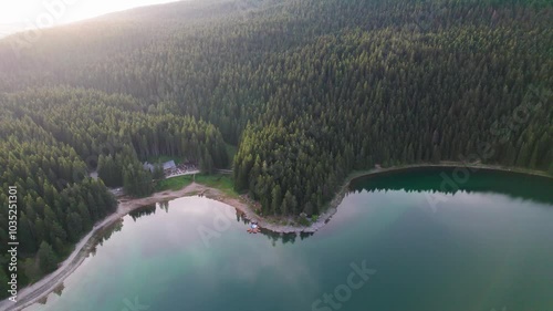 Aerial view of Crno Jezero lake surrounded by majestic mountains and serene trees, Zabljak, Montenegro. photo