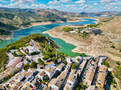 Aerial view of tranquil Iznajar village with beautiful lake, mountains, and serene countryside, Cordoba, Spain. photo