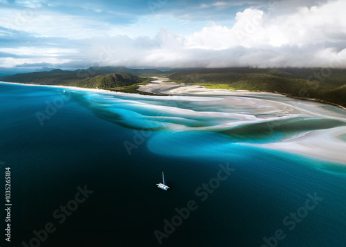 Aerial view of whitehaven beach with serene blue waters and sailing boats, whitsundays, australia. photo