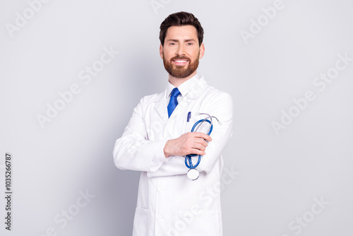 Photo of confident handsome doctor intern wear white coat work in medical center isolated on grey color background