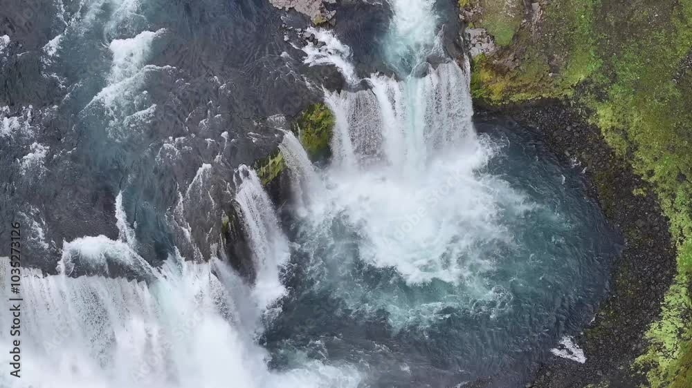 Aerial view of a breathtaking waterfall cascading into a serene river surrounded by vibrant greenery, Axalfoss, Iceland. Aerial view of a breathtaking waterfall cascading into a serene river surrounded by vibrant greenery, Axalfoss, Iceland.