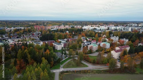 Golden autumn trees brighten northern city in autumn, aerial view photo