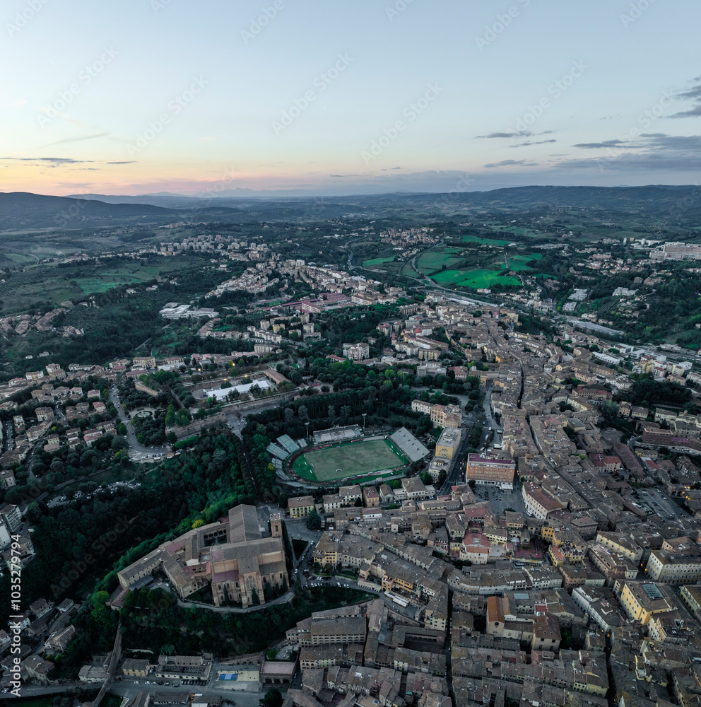 Aerial view of the beautiful medieval city with historic buildings and scenic hills, Siena, Italy. Aerial view of the beautiful medieval city with historic buildings and scenic hills, Siena, Italy.
