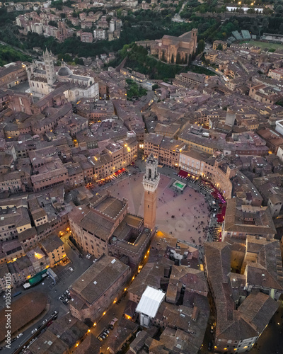 Aerial view of the historic piazza del campo surrounded by medieval buildings and rooftops, Siena, Italy.