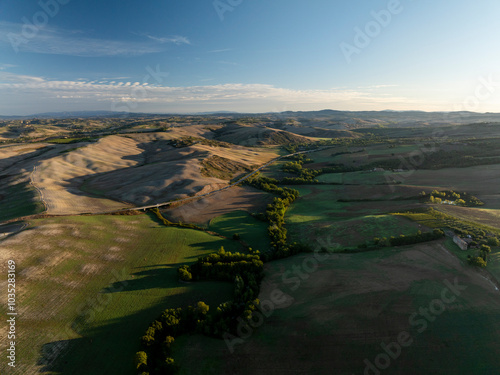 Aerial view of beautiful rolling hills and expansive fields under a serene sky, San Quirico d'Orcia, Italy. photo