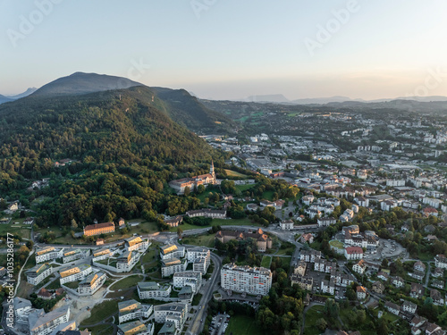 Aerial view of beautiful Vieille Ville with Basilique de la Visitation surrounded by mountains and forest at sunset, Annecy, France. photo