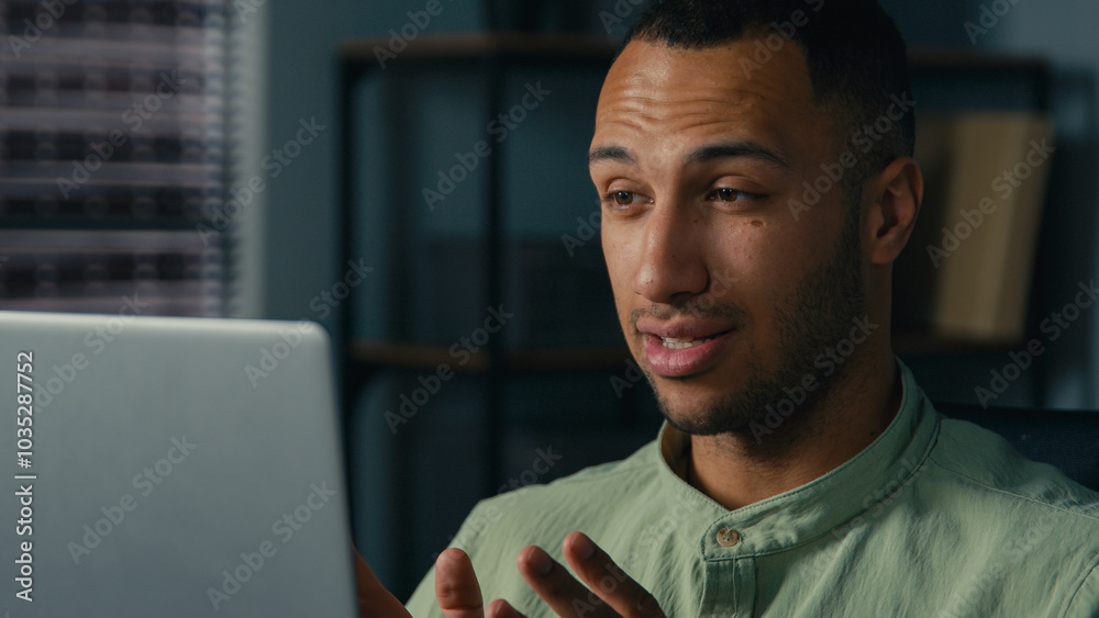 Close-up smiling african american man businessman male corporate employee manager talking video call using laptop computer in office remote conversation online conference webinar business negotiating Close-up smiling african american man businessman male corporate employee manager talking video call using laptop computer in office remote conversation online conference webinar business negotiating