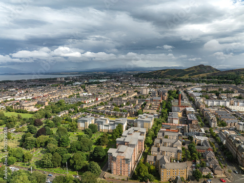 Aerial view of urban landscape with buildings and Arthur Seat volcano under cloudy sky, Powderhall, Edinburgh, United Kingdom. photo