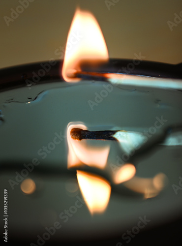 burning match reflecting in the mirror