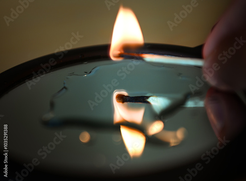 burning match reflecting in the mirror