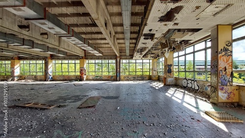 Abandoned industrial hall, graffiti-streaked walls under a collapsing ceiling