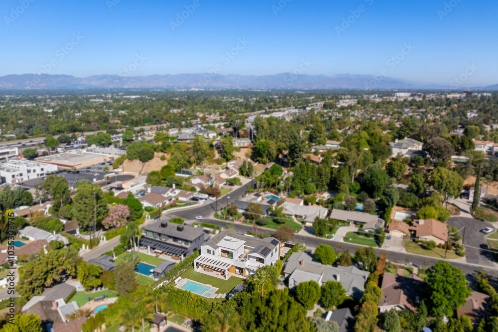 Aerial view of Los Angeles suburb with homes and mountains. Aerial view of Los Angeles suburb with homes and mountains.