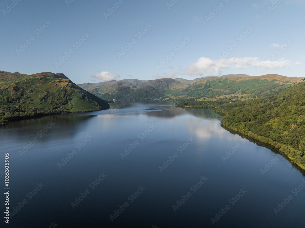 Aerial view of serene Ullswater lake surrounded by majestic hills and mountains, Lake District, United Kingdom. Aerial view of serene Ullswater lake surrounded by majestic hills and mountains, Lake District, United Kingdom.