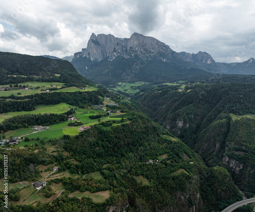 Aerial view of the picturesque Seiser Alm valley surrounded by majestic mountains and lush greenery, Kastelruth, Italy. photo