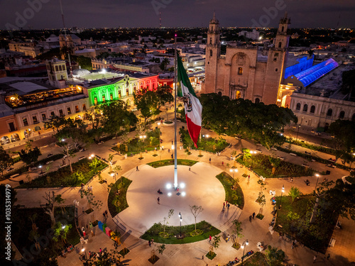 Aerial view of vibrant Plaza Grande with illuminated colonial buildings and bustling people, Merida, Mexico. photo