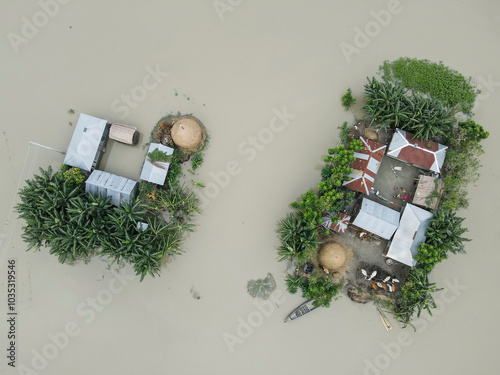 Aerial view of flood water surrounding homes and boats in a suburban landscape, Jatrapur, Kurigram, Bangladesh. photo