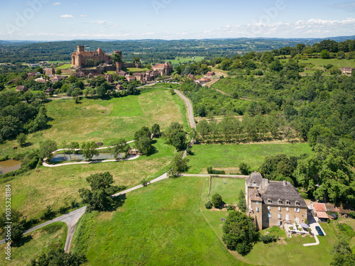 Aerial view of chateau de castelnau-bretenoux surrounded by picturesque countryside and tranquil village, Prudhomat, France. photo