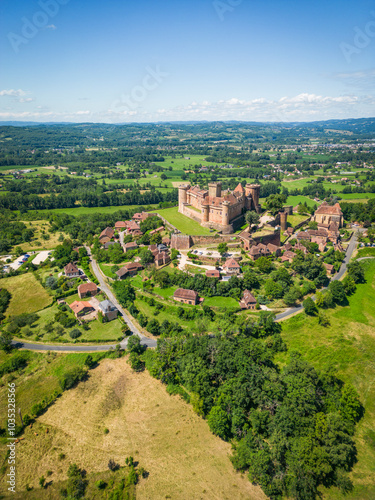 Aerial view of chateau de castelnau bretenoux surrounded by lush countryside and picturesque village, Prudhomat, France. photo