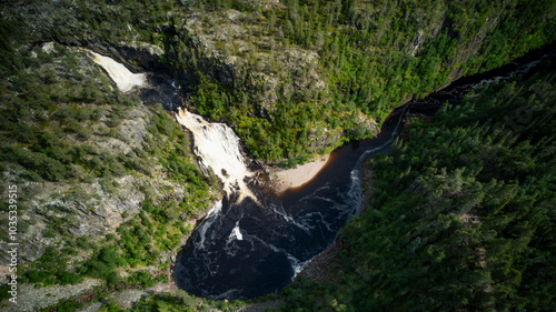 Aerial view of muddus fall surrounded by lush forest and scenic cliffs, muddus national park, lapland, sweden. photo