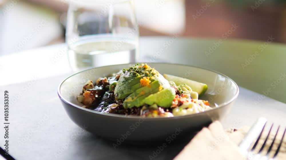 !Poke bowl with avocado and quinoa sits invitingly on restaurant table health and gourmet cuisine. Poke bowl with avocado and quinoa sits elegantly on restaurant table ready to delight diner. !Poke bowl with avocado and quinoa sits invitingly on restaurant table health and gourmet cuisine. Poke bowl with avocado and quinoa sits elegantly on restaurant table ready to delight diner.
