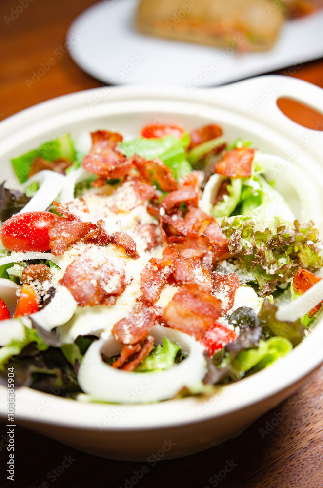 Salad with bacon and cheese and Caesar dressing Salad with bacon and cheese and Caesar dressing