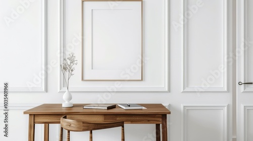 A minimalist home office with white walls and a wooden desk. The desk features a blank picture frame and a small notebook. Bright