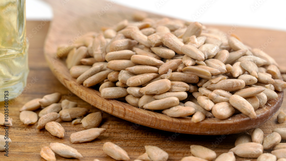 peeled sunflower seeds on a wooden background peeled sunflower seeds on a wooden background