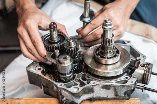 Obraz na płótnie Motorcycle mechanic working on the repair of a motorcycle engine ,working at garage, maintenance, repair motorcycle concept w salonie