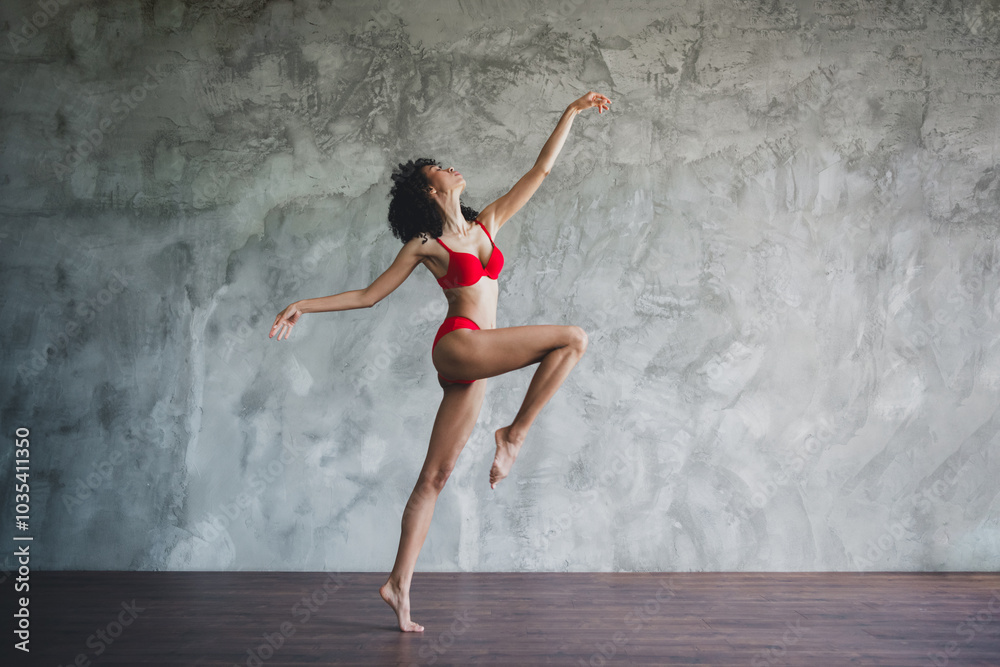 Full body length photo of young american model sportive body lady wearing red seductive lingerie posing isolated on gray studio background Full body length photo of young american model sportive body lady wearing red seductive lingerie posing isolated on gray studio background