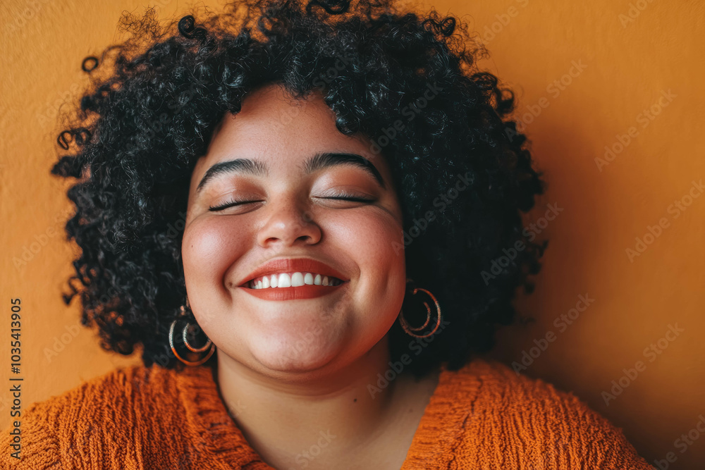 Fototapeta premium Closeup Portrait Of A Happy And Confident Young Overweight Woman Against Orange Background. Confident Smiling Woman Closeup