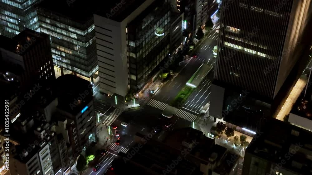 Nighttime aerial view of Tokyo city streets with moving traffic and illuminated buildings Nighttime aerial view of Tokyo city streets with moving traffic and illuminated buildings