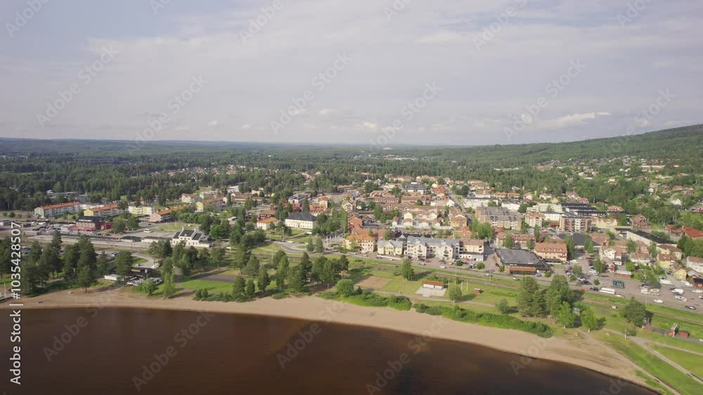 Aerial view of a beautiful cityscape with traditional houses and serene lake surrounded by greenery, Rattvik, Sweden. Aerial view of a beautiful cityscape with traditional houses and serene lake surrounded by greenery, Rattvik, Sweden.