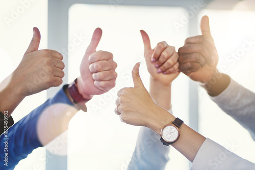 Business people, hands and thumbs up in office for support, good job or positive reinforcement. Corporate team, emoji gesture or yes sign in workplace for approval, agreement or project collaboration photo