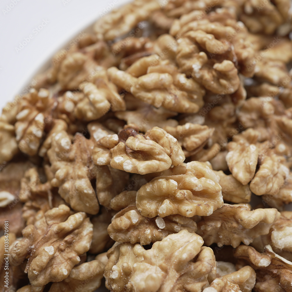 Close-up view of walnut halves, showcasing the intricate details and textures of these nutritious nuts. The image highlights the natural beauty and richness of walnuts Close-up view of walnut halves, showcasing the intricate details and textures of these nutritious nuts. The image highlights the natural beauty and richness of walnuts
