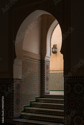 View of the ornate mausoleum of Moulay Ismail with intricate tilework and arched doorways, Meknes, Morocco. photo