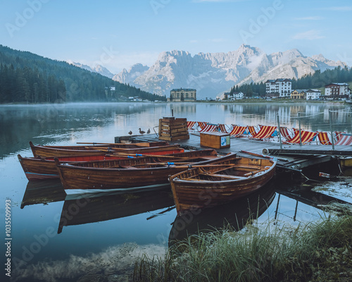 View of serene Lake Misurina with wooden boats and tranquil reflections, Auronzo di Cadore, Italy. photo