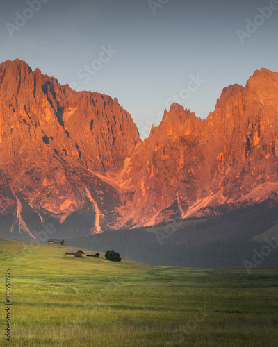 View of beautiful sunset over majestic mountains and serene grassland, Alpe di Siusi, Italy. photo