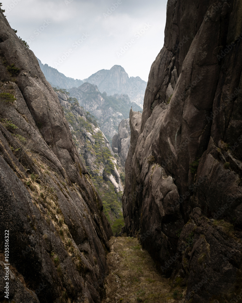 View of majestic rock formations and steep cliffs in a breathtaking mountainous landscape, Huangshan, China. View of majestic rock formations and steep cliffs in a breathtaking mountainous landscape, Huangshan, China.