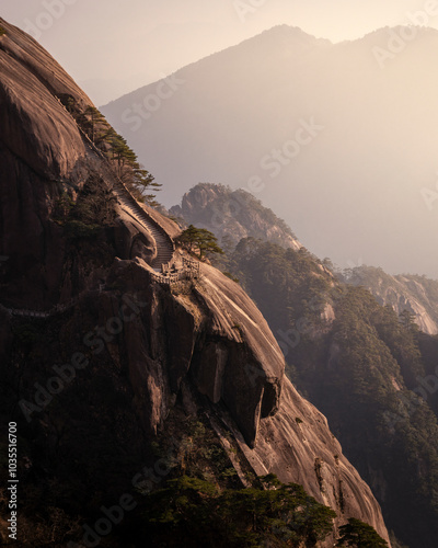 View of majestic Huangshan mountain with scenic pathway and towering trees at sunset, Huangshan, China. photo