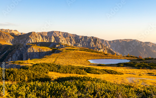 View of serene autumn landscape with majestic Hochschwab mountain and tranquil lake, Aflenz, Austria.