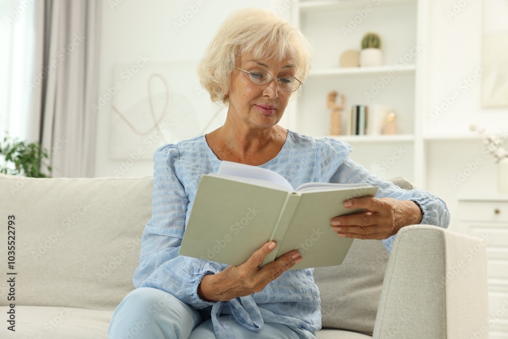 Beautiful senior woman reading book at home Beautiful senior woman reading book at home