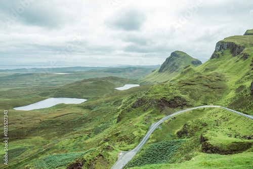 View of dramatic Quiraing landscape with winding road and serene valley, Portree, United Kingdom. photo