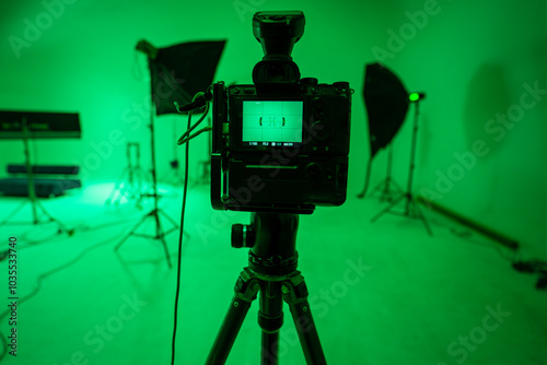 Professional video studio behind-the-scenes video footage behind-the-scenes silhouette production photography with focus on camera and studio equipment..