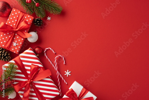 Elegant top view Christmas presents with red ribbons and various festive decorations arranged on a vibrant red background, conveying warmth and holiday cheer