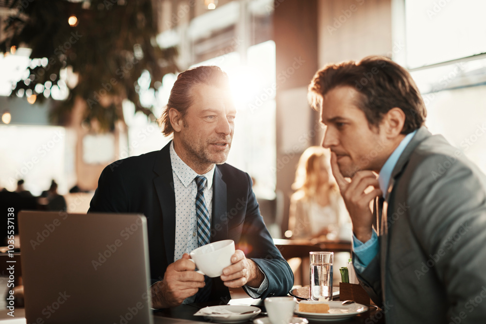 Two businessman having coffee and a meeting in a cafe bar decorated for christmas and the new years holidays Two businessman having coffee and a meeting in a cafe bar decorated for christmas and the new years holidays