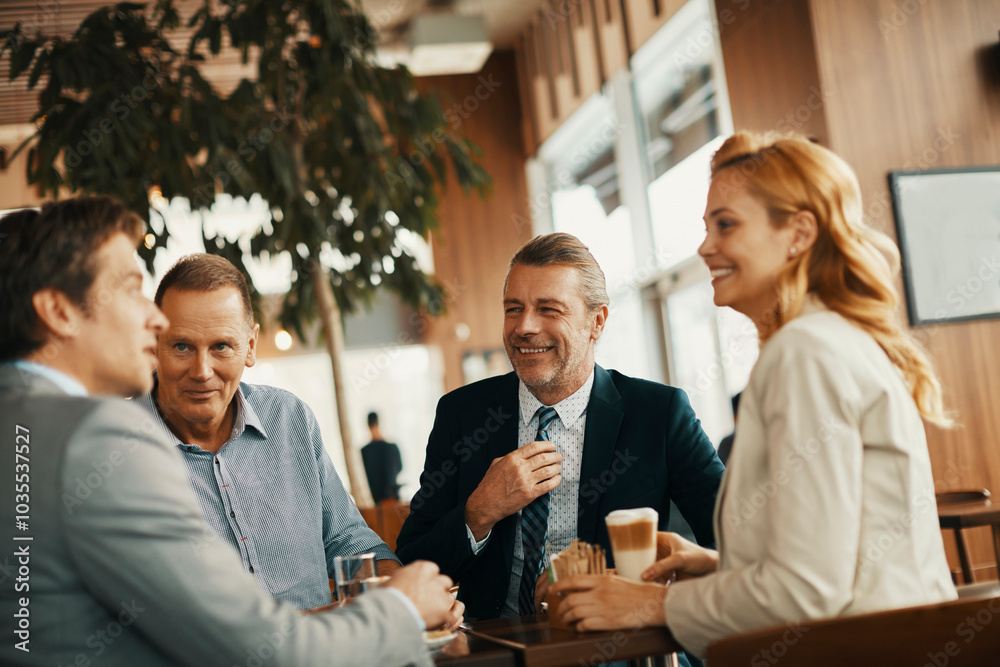 Fototapeta premium Group of business people having coffee and talking in a cafe decorated for the christmas and new year holidays