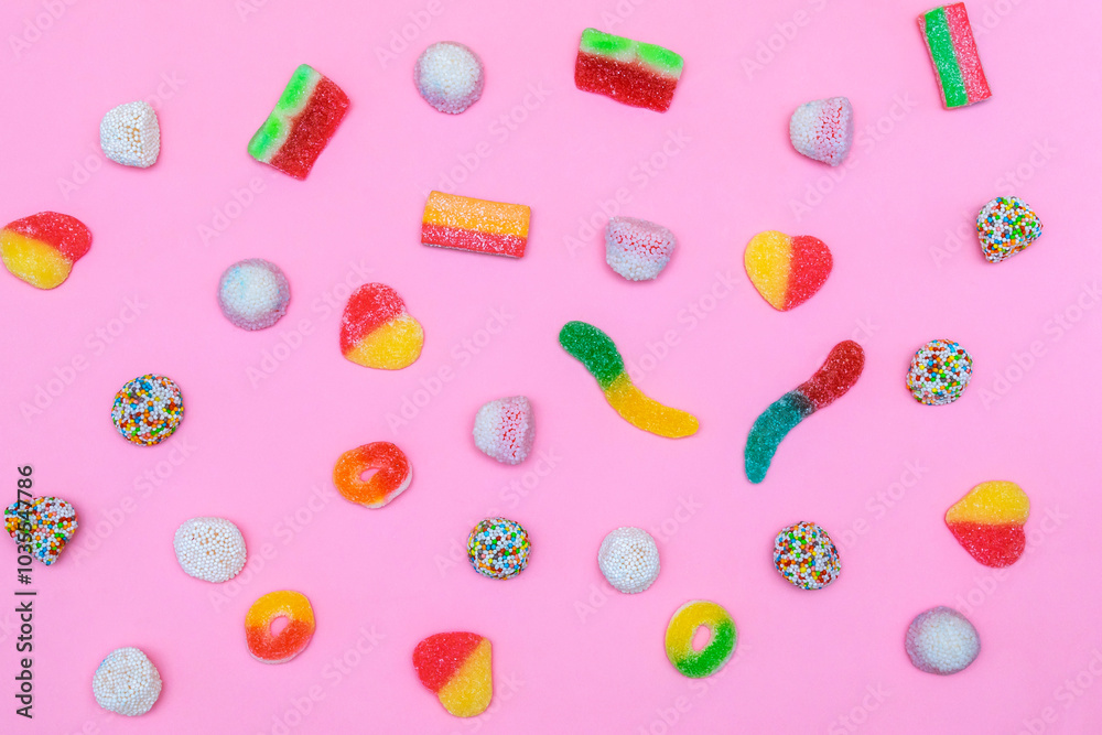 Colorful sweet jelly candies on pastel pink background close up.Food dessert unhealthy,pastry,confectionery, desserts,flat lay, flatly, layout, top view. Colorful sweet jelly candies on pastel pink background close up.Food dessert unhealthy,pastry,confectionery, desserts,flat lay, flatly, layout, top view.