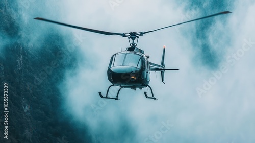 Helicopter flying close to a waterfall, mist rising in the air