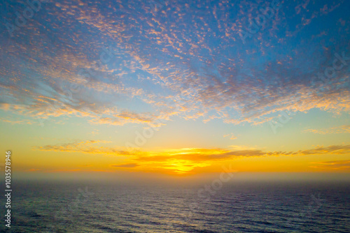 Dramatic sunset sky with clouds over the ocean