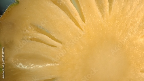 The pineapple slice, creating a sense of freshness. A close-up of a sliced pineapple reveals a tropical paradise. Sun-kissed yellow golden flesh with juice, contrasts the rough brown rind. Comestible. photo